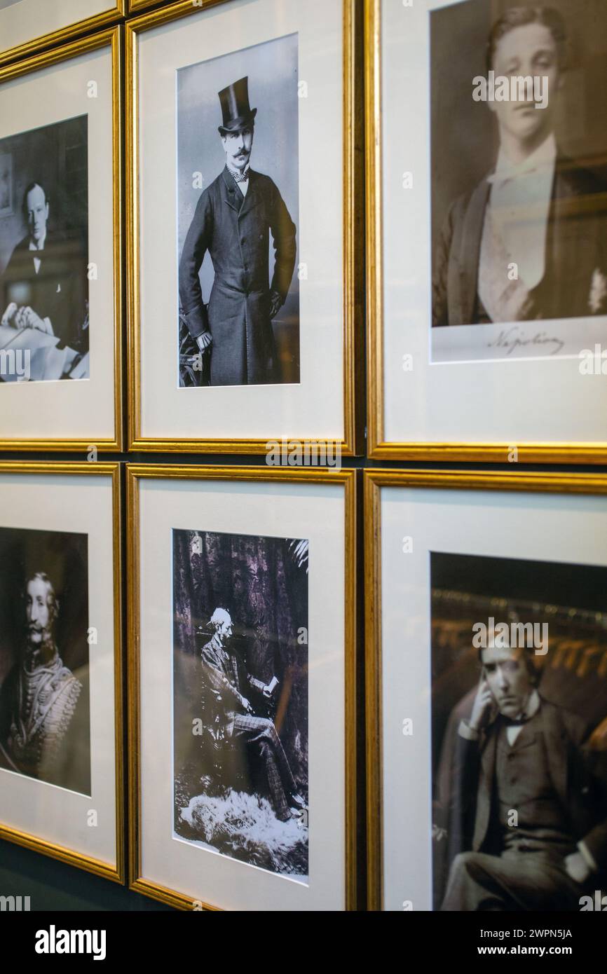 Old framed photographs of famous people on  wall Stock Photo