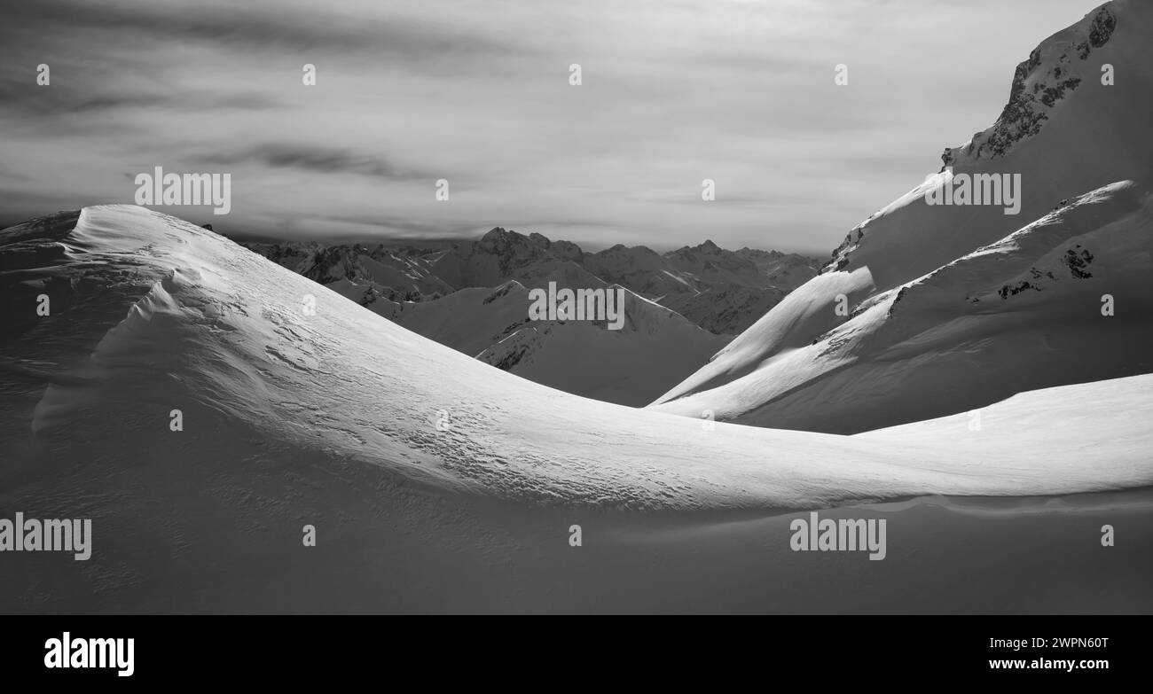 Wind-sculpted snowy landscape in the mountains in black and white on the Big Thumb. Allgäu Alps, Bavaria, Germany, Europe Stock Photo