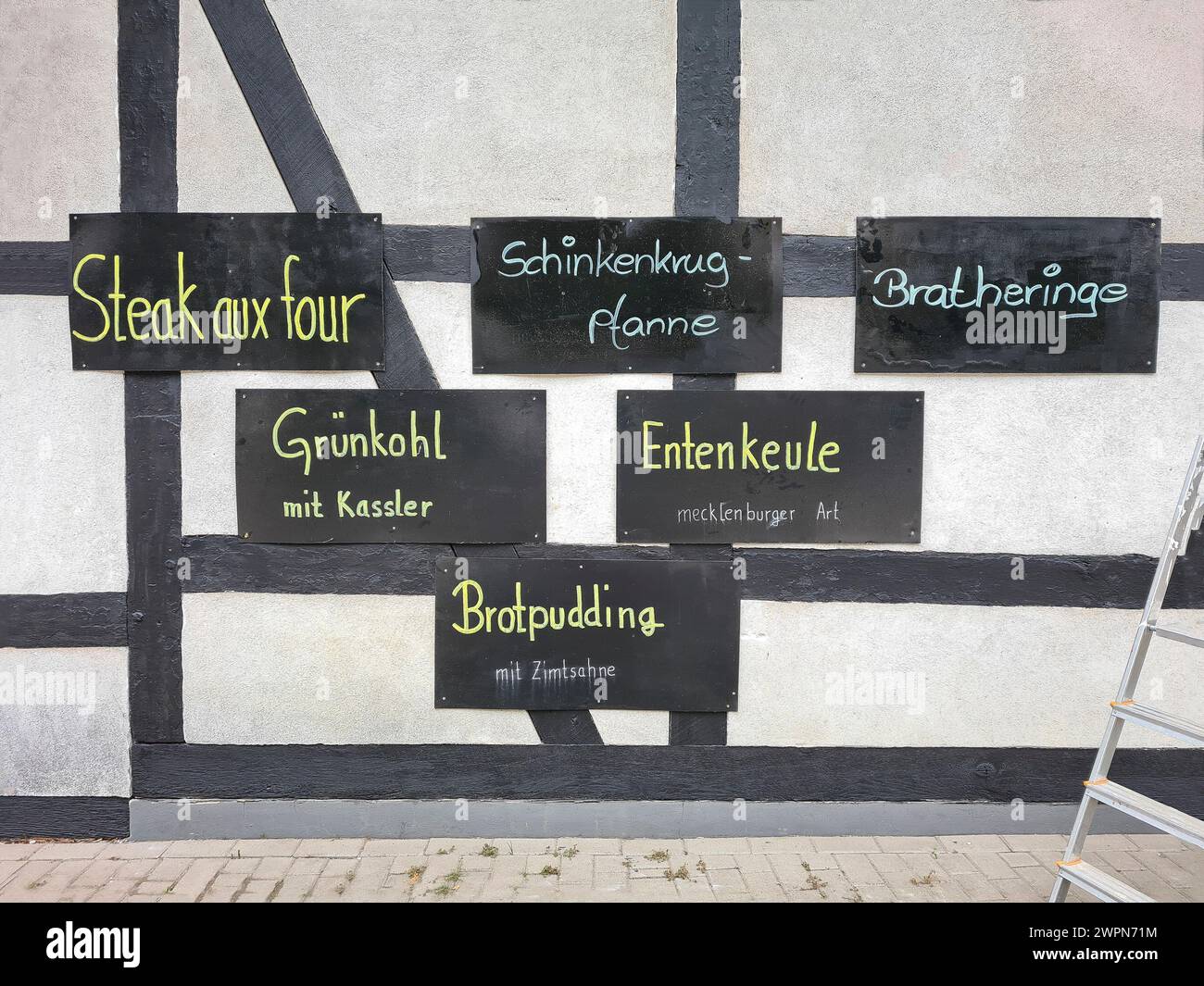 Handwritten signs advertising specialties and dishes of the Restaurant am Fachwerkhaus, Markgrafenheide, Germany Stock Photo