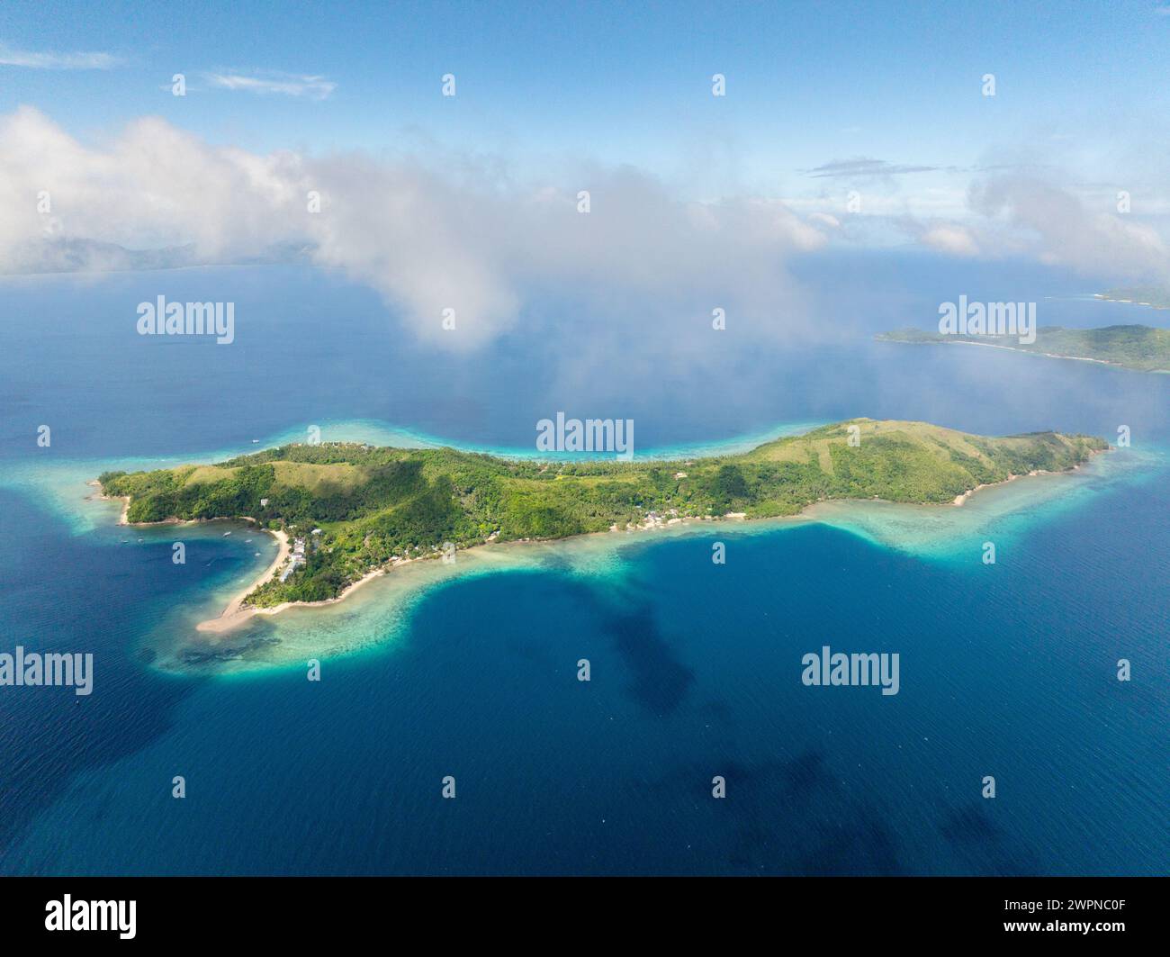 Clouds over the Logbon Island surrounded by blue sea. Romblon, Philippines. Stock Photo