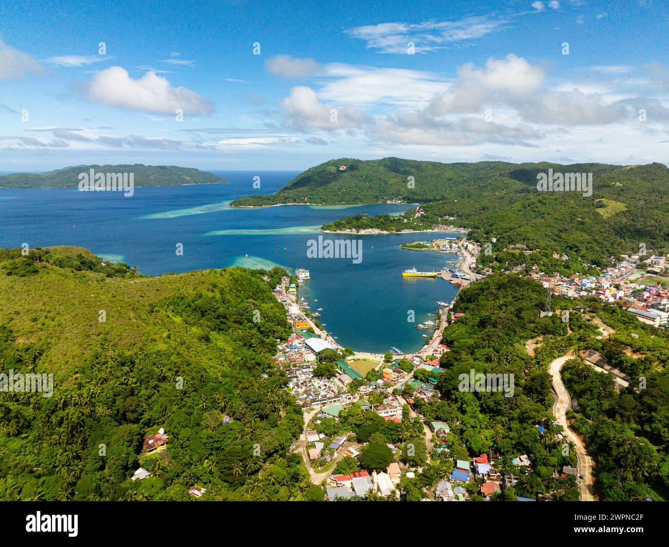 Port Romblon with ferry and boats. Coastal town city in Romblon Island, Romblon, Philippines. Stock Photo