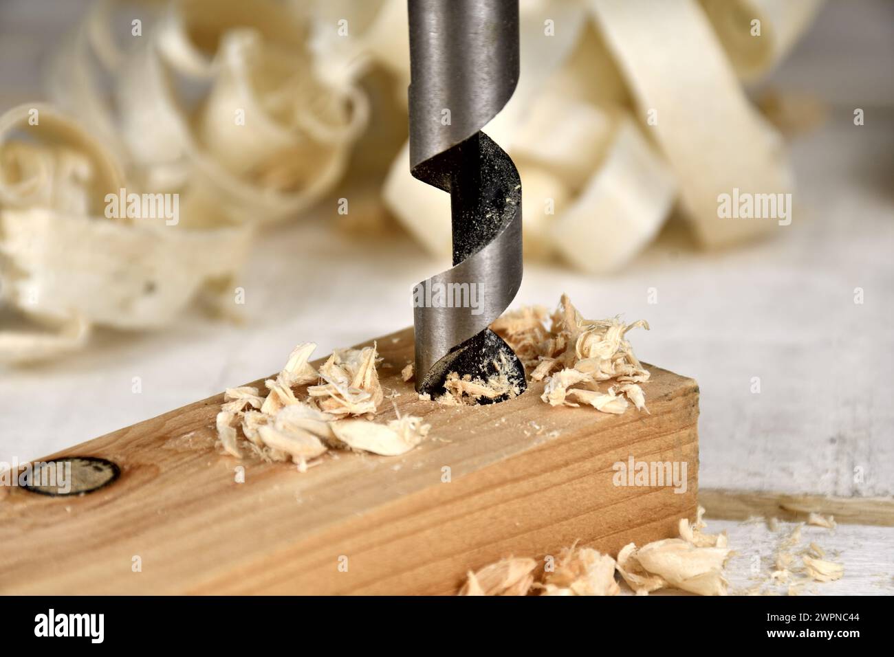 Single flute auger bit drilling through wood piece Stock Photo Alamy