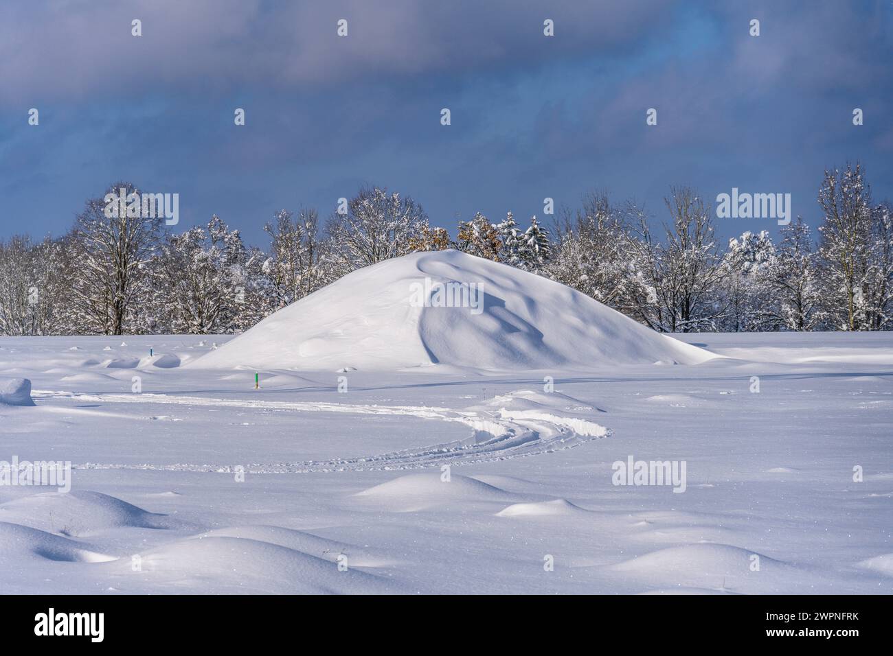 Germany, Bavaria, district of Munich, Oberhaching, Schrannenweg, snow-covered mound of rubble Stock Photo