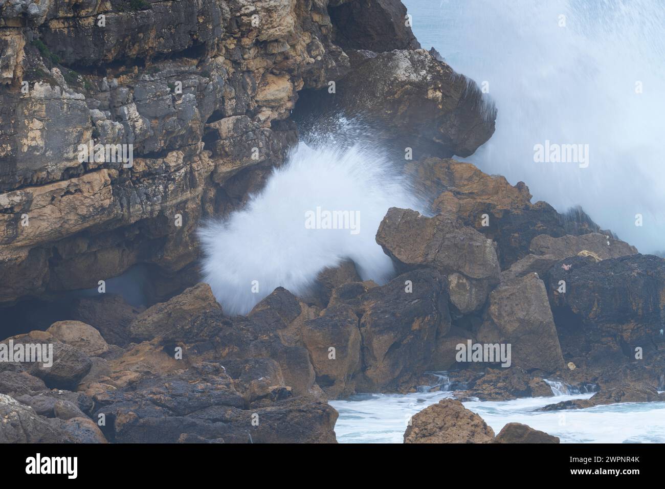 Natural arch on the coast of Santander and storm surge with big waves. Santander Municipality. Cantabrian Sea. Cantabria. Spain. Europe Stock Photo