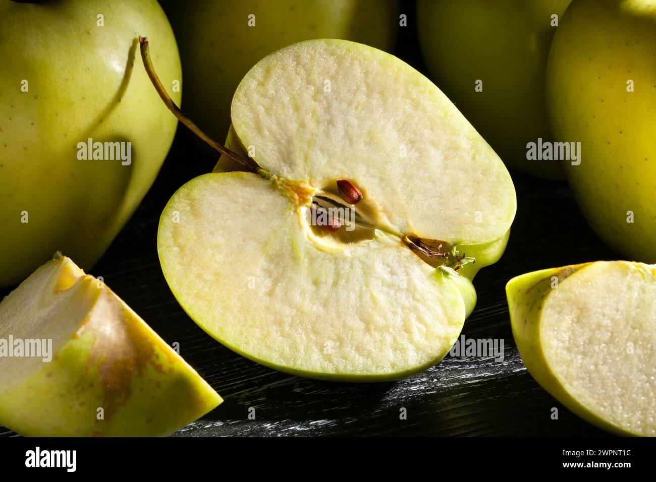 sliced apple on black wood background Stock Photo