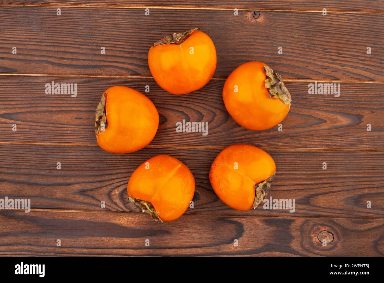 persimmon on wood background top view Stock Photo