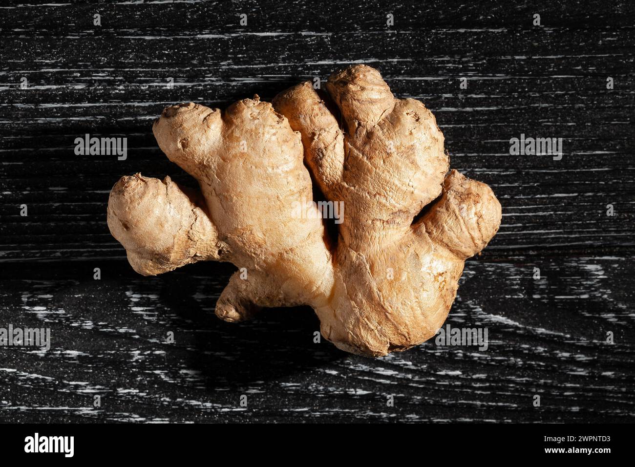 ginger on black wood background top view Stock Photo