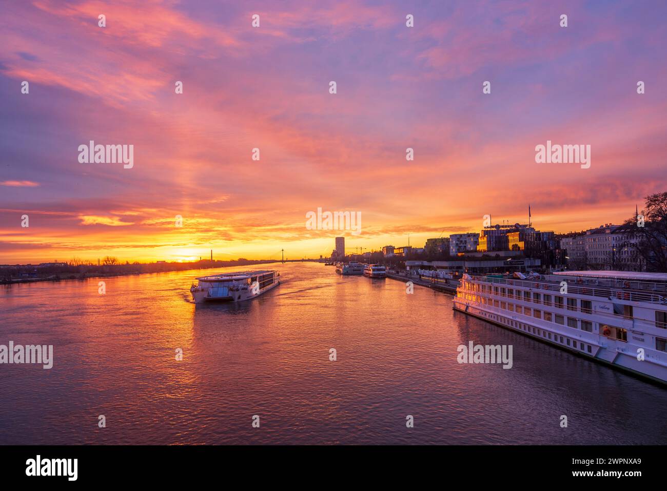 Vienna, river Donau (Danube) at sunrise, cruise ships, jetty, bridge Donaustadtbrücke, Marina Tower in 02. Leopoldstadt, Wien, Austria Stock Photo