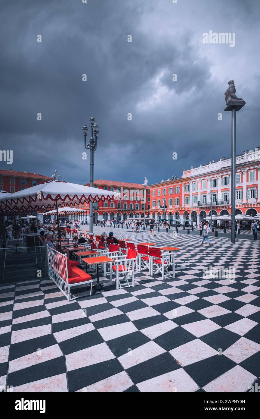 Place Massena in Nice with chessboard flooring and bistro in the foreground during a thunderstorm Stock Photo