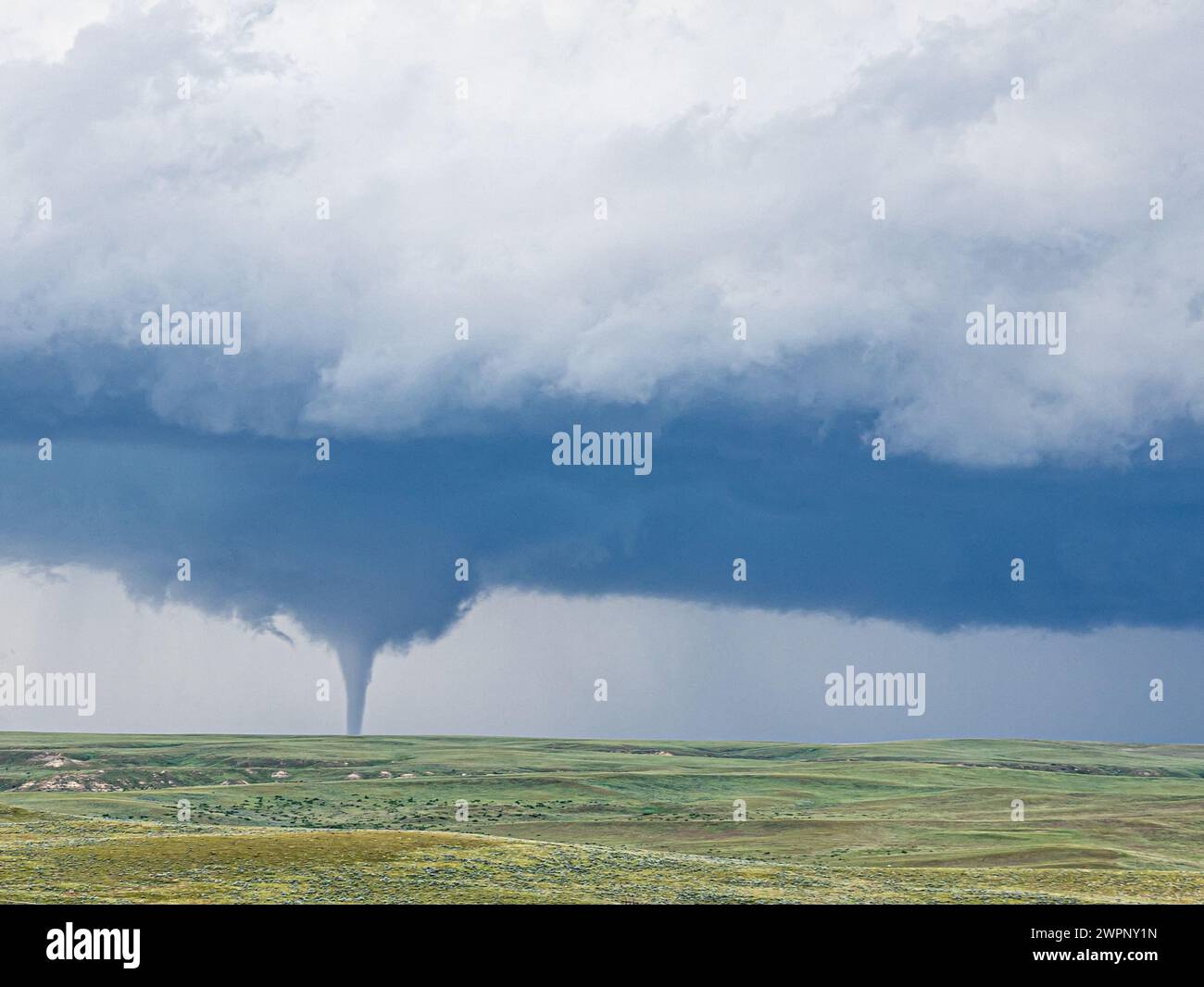 A cloud funnel over a green landscape in the north of Casper, Wyoming