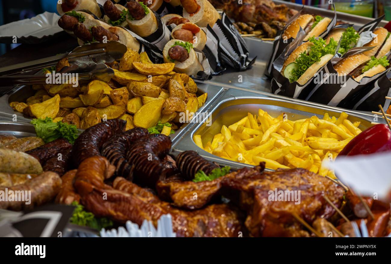 grilled sausages, vegetables, salads on the counter in the food court ...