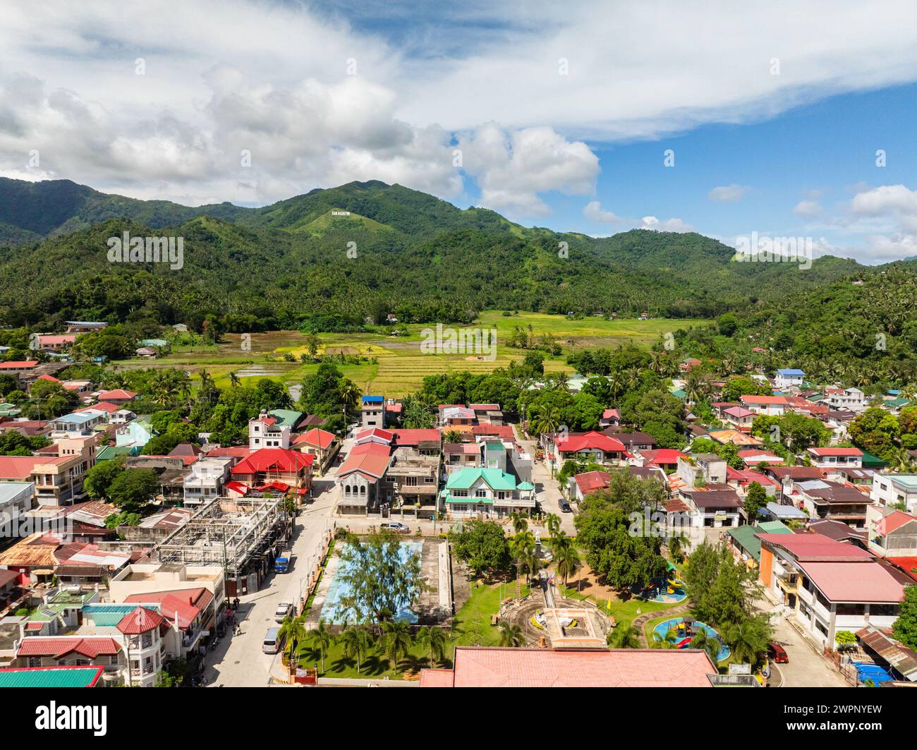 Buildings and houses in town city of San Agustin, Romblon. Blue sky and clouds. Philippines. Stock Photo