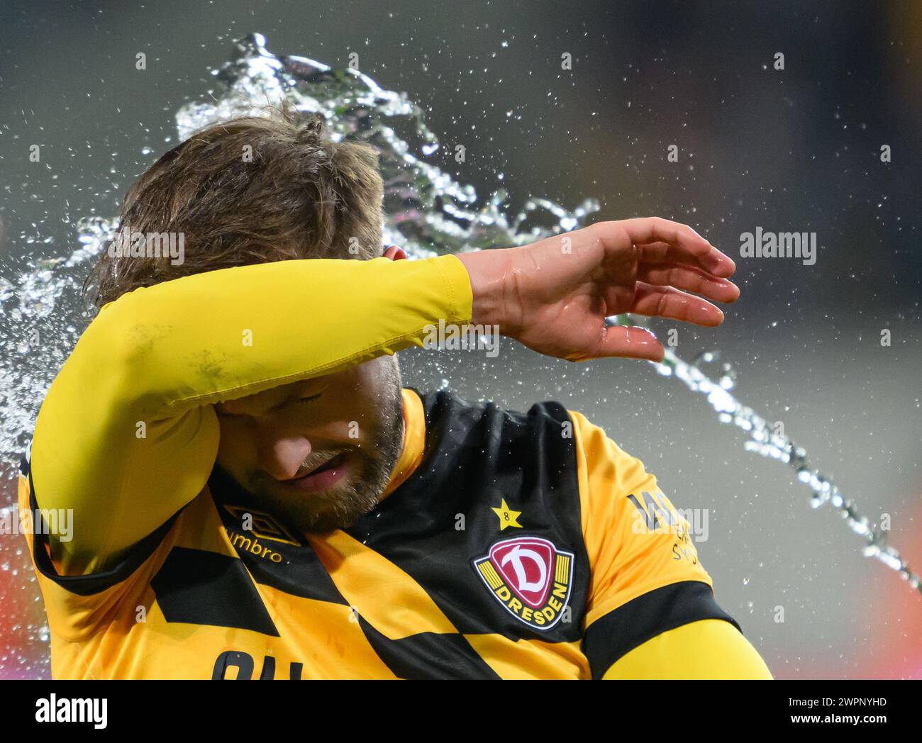 Dresden, Germany. 08th Mar, 2024. Soccer: 3rd division, SG Dynamo Dresden - TSV 1860 Munich, matchday 29, Rudolf-Harbig-Stadion. Dynamo's Lucas Cueto is splashed with water after the win. Credit: Robert Michael/dpa/ZB/dpa/Alamy Live News Stock Photo