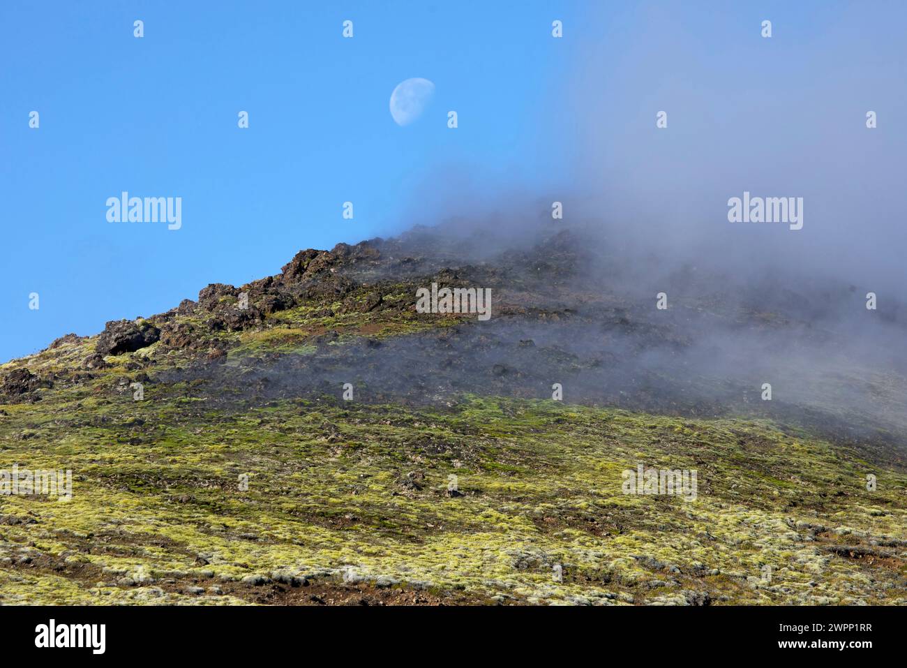 The moon stands above the steaming volcanic slopes of the Jardbadsholar ...