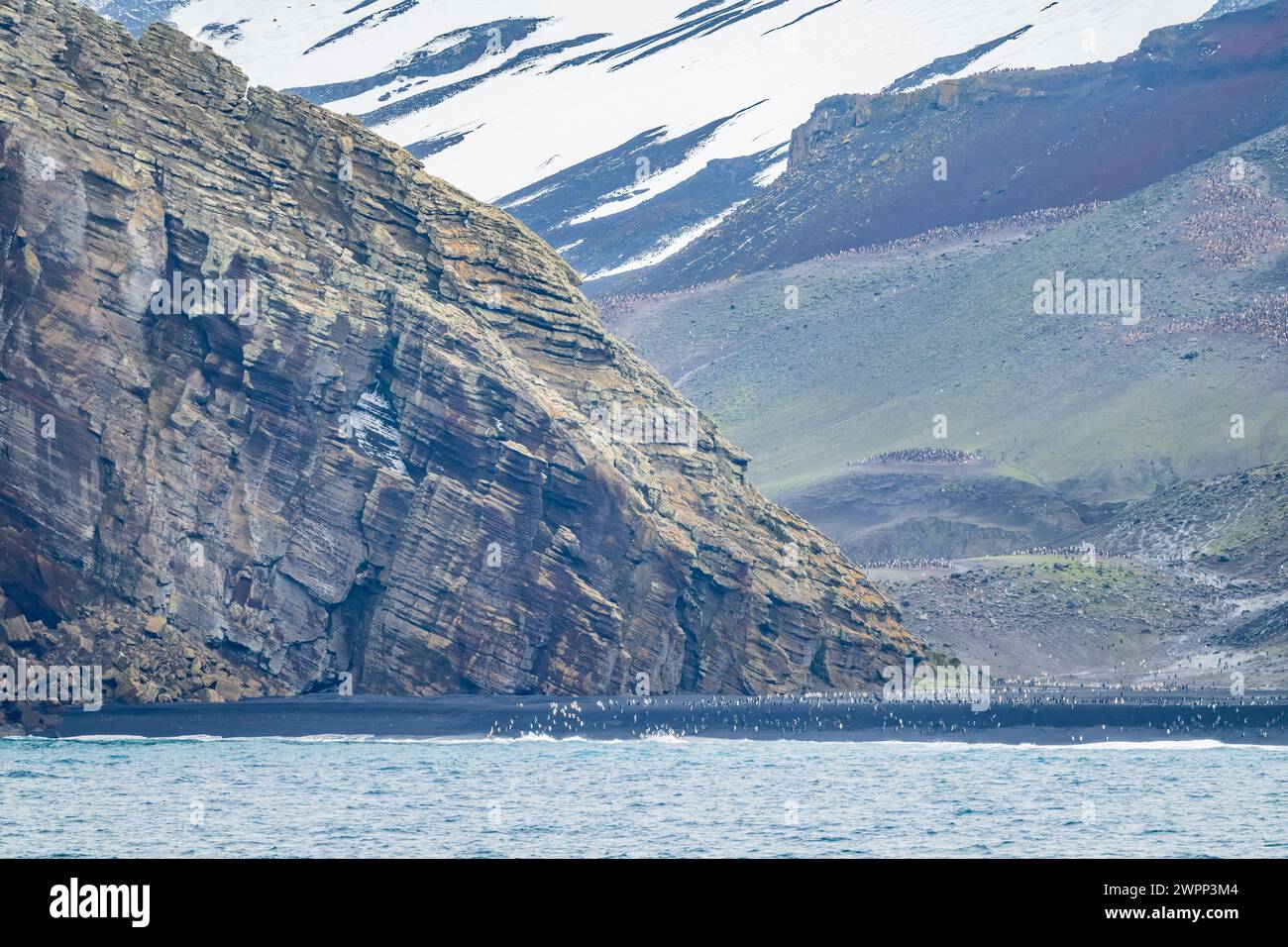 Layers of volcanic ash deposits form the cliff on the coast. Deception Island, Antarctica. Stock Photo