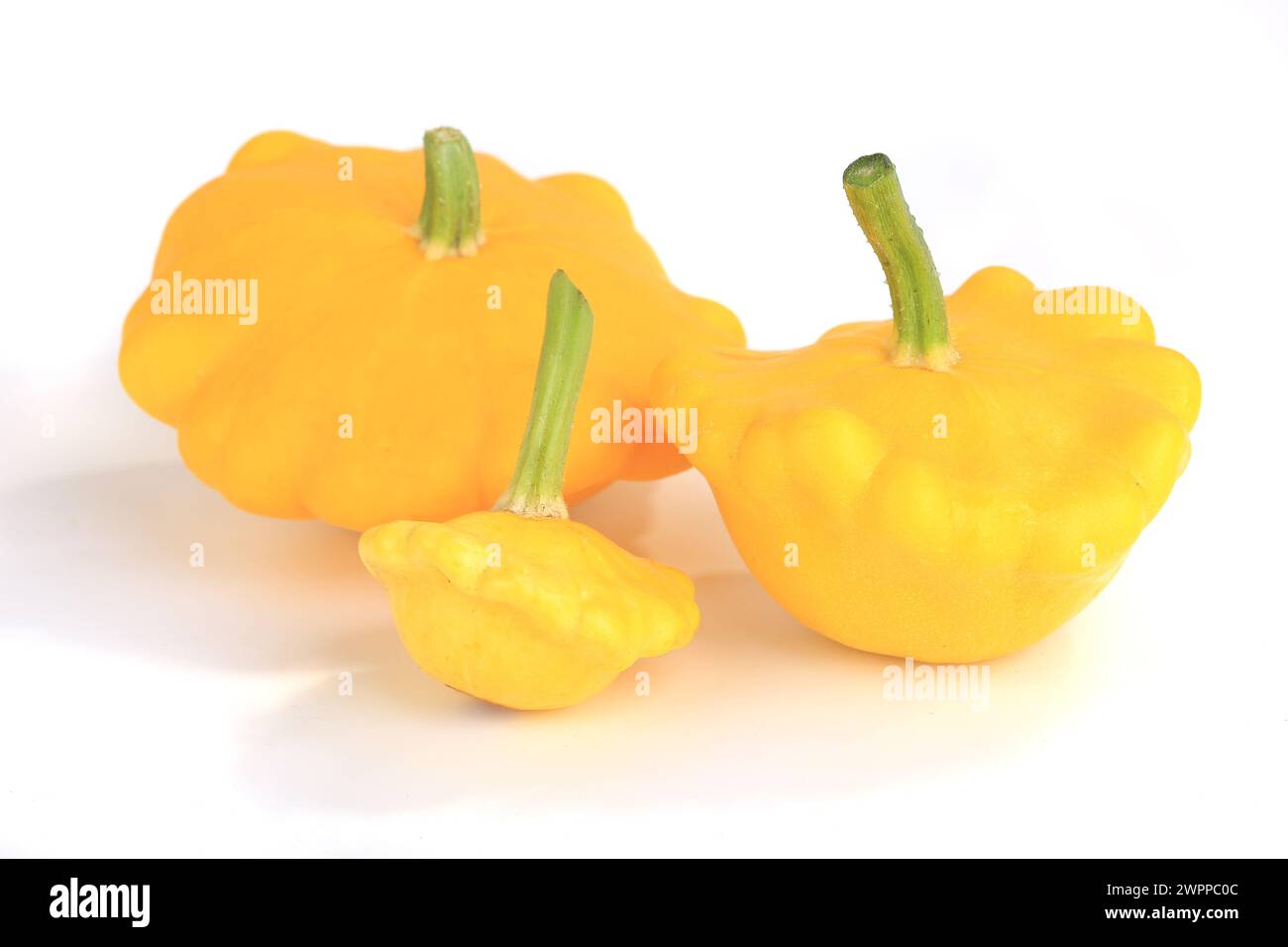 Three yellow bush pumpkins isolated on white background Stock Photo - Alamy