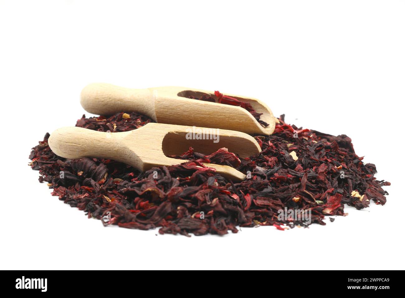 Karkade tea. Hibiscus tea leaves in wooden scoop isolated on white background. File contains clipping path. Top view. Stock Photo