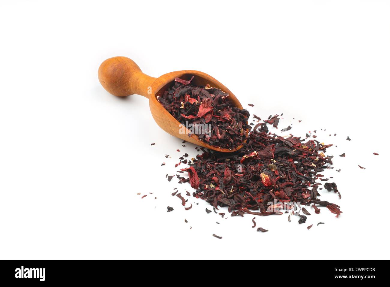 Karkade tea. Hibiscus tea leaves in wooden scoop isolated on white background. File contains clipping path. Top view. Stock Photo