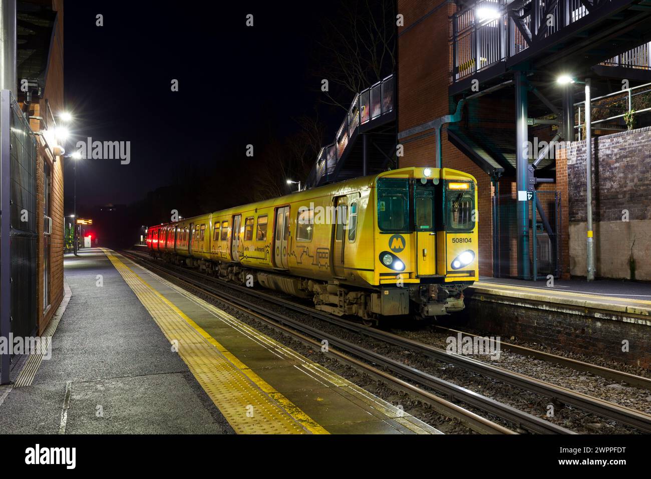 Merseyrail electrics class 508 third rail electric train 508104 at St Michaels railway station, Liverpool, UK at night Stock Photo