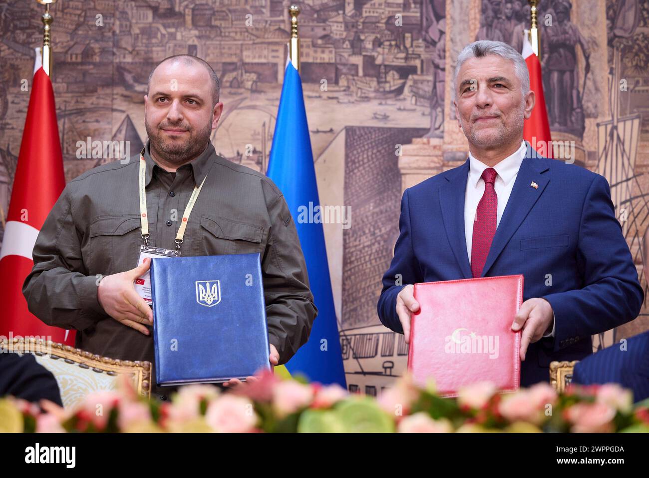 Istanbul, Turkey. 08th Mar, 2024. Ukraine Defense Minister Rustem Umerov, left, and Turkish Trade Minister Omer Bolat hold up signed agreements at Dolmabahce palace, March 8, 2024 in Istanbul, Turkey. The agreement establishes an electronic preliminary information exchange system between the two nations. Credit: Ukraine Presidency/Ukrainian Presidential Press Office/Alamy Live News Stock Photo