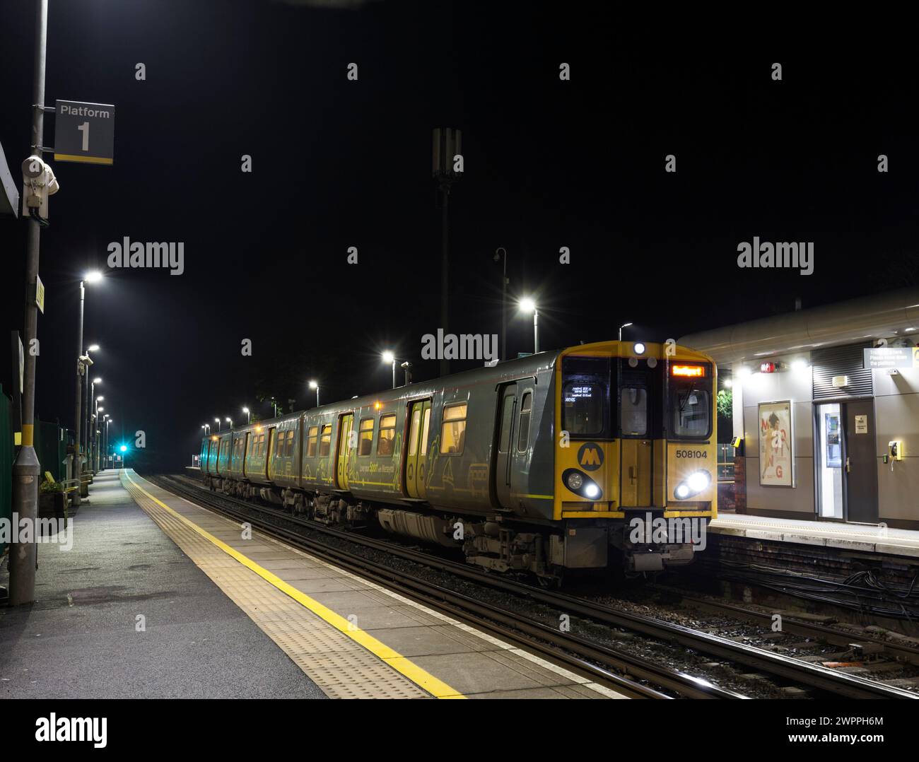 Merseyrail electrics class 508 third rail electric train 508104 at Ainsdale railway station, Southport, UK at night Stock Photo
