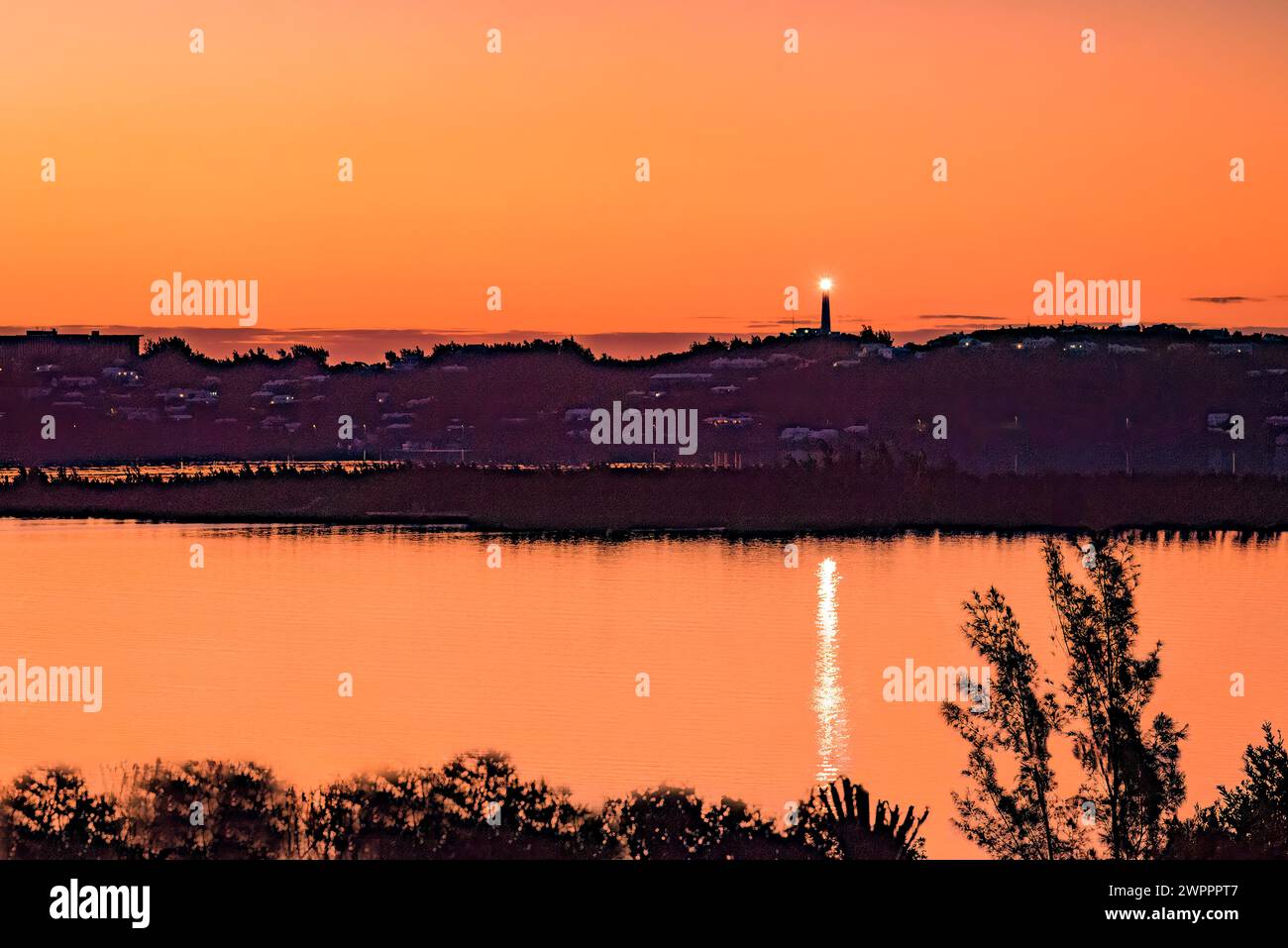 Gibbs Hill Lighthouse at Dawn with Light and Sky Reflecting in Little Sound Bermuda Stock Photo