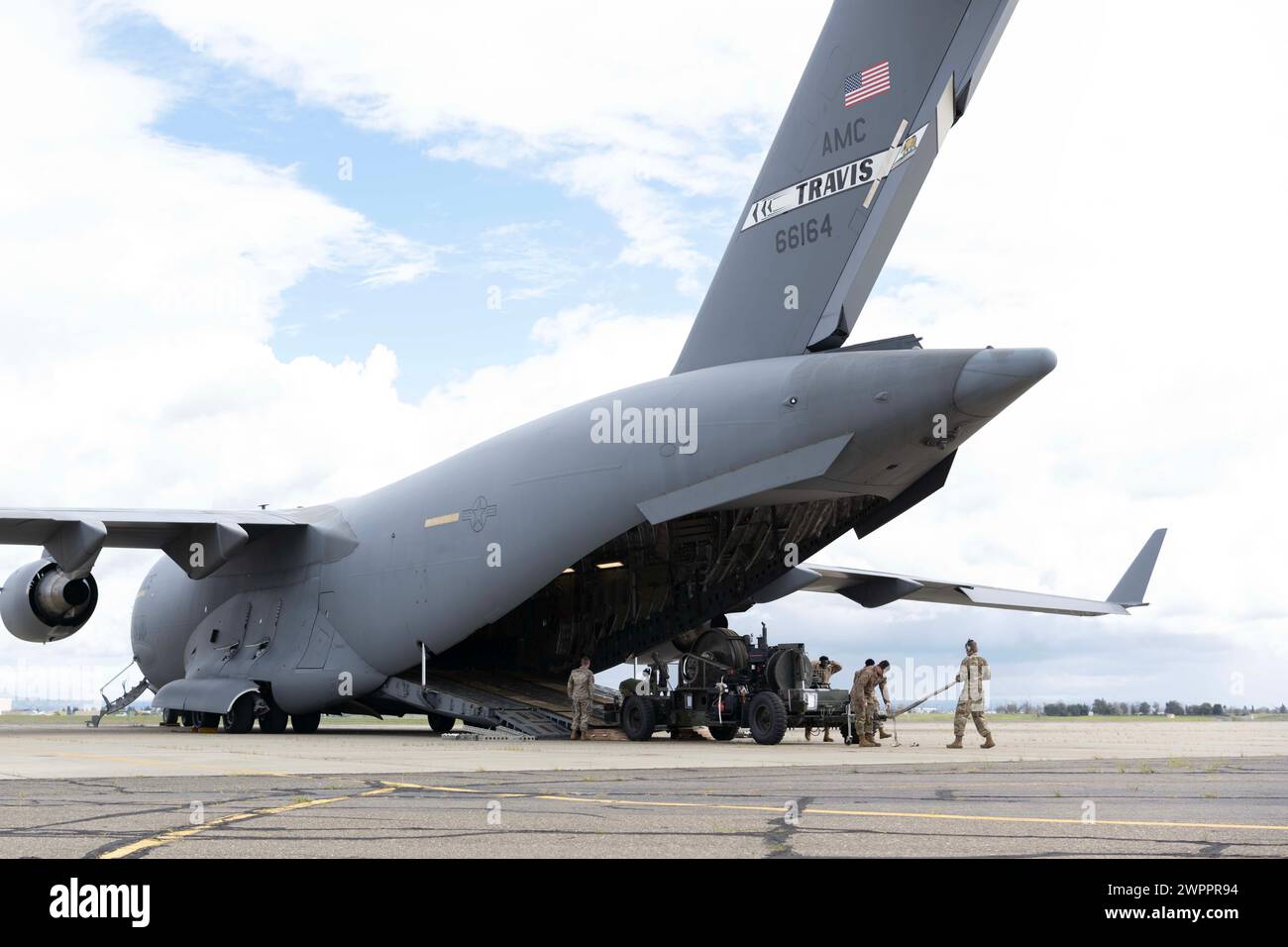 U.S. Airmen assigned to Travis Air Force Base, California, offload a Mobile Aircraft Arresting System from a C-17 Globemaster III at Mather Airport, California, March 3, 2024. Airmen assigned to the 21st Airlift Squadron transported the MAAS, an aircraft braking system, to Mather to be used in the event of an emergency during Travis AFB’s 2024 Wings Over Solano Airshow and Open House. (U.S. Air Force photo by Senior Airman Alexander Merchak) Stock Photo