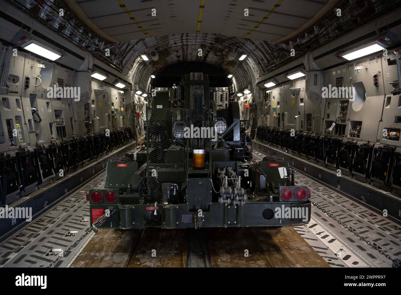 A Mobile Aircraft Arresting System sits in the cargo hold of a C-17 Globemaster III at Nellis Air Force Base, Nevada, March 3, 2024. Airmen assigned to the 21st Airlift Squadron transported the MAAS, an aircraft braking system, to Mather Airport, California, to be used in the event of an emergency during 2024 Wings Over Solano Airshow and Open House. (U.S. Air Force photo by Senior Airman Alexander Merchak) Stock Photo