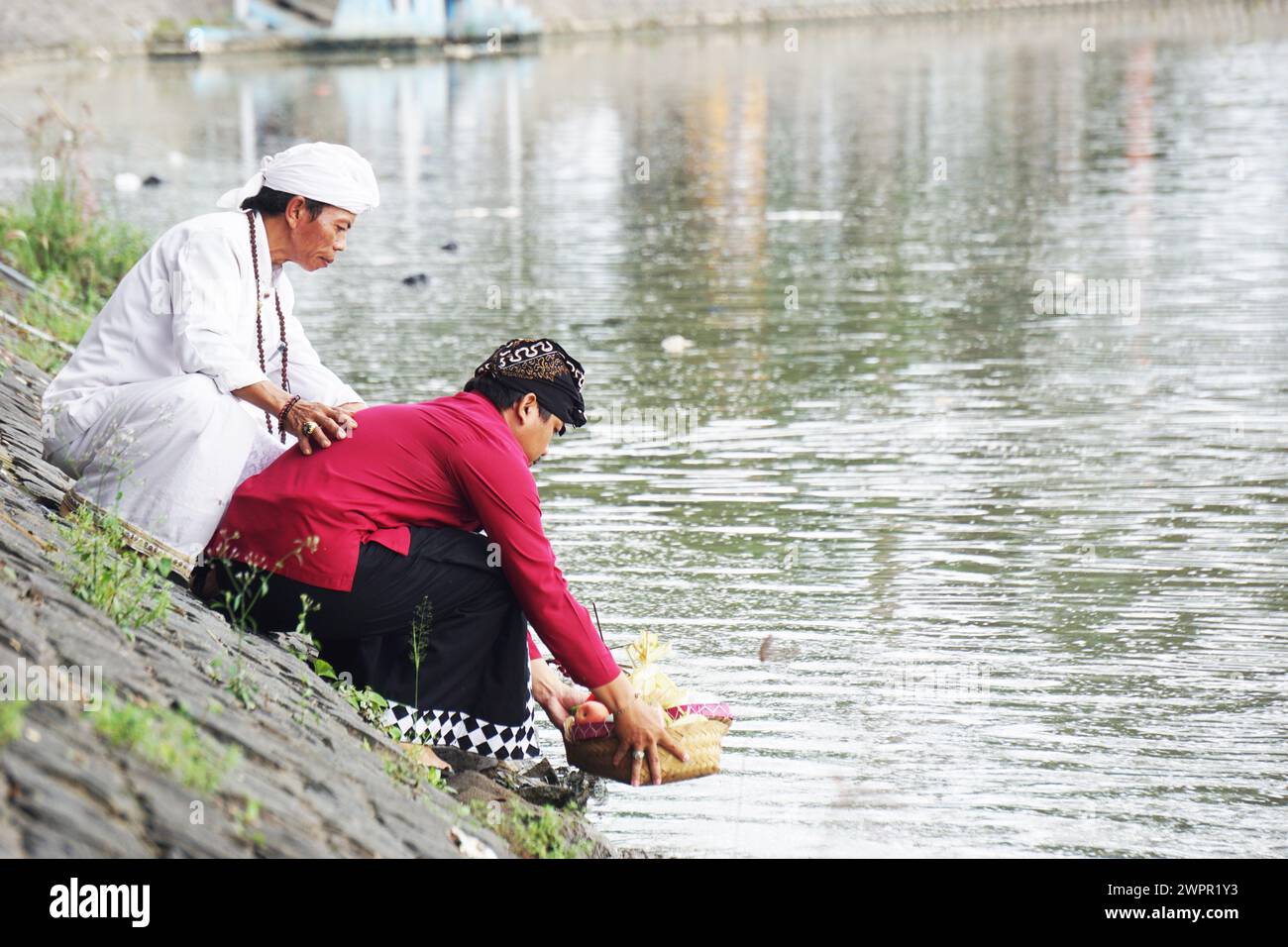 Hindus carry out prayers in the context of the Melasti ceremony ahead of Nyepi Day Stock Photo