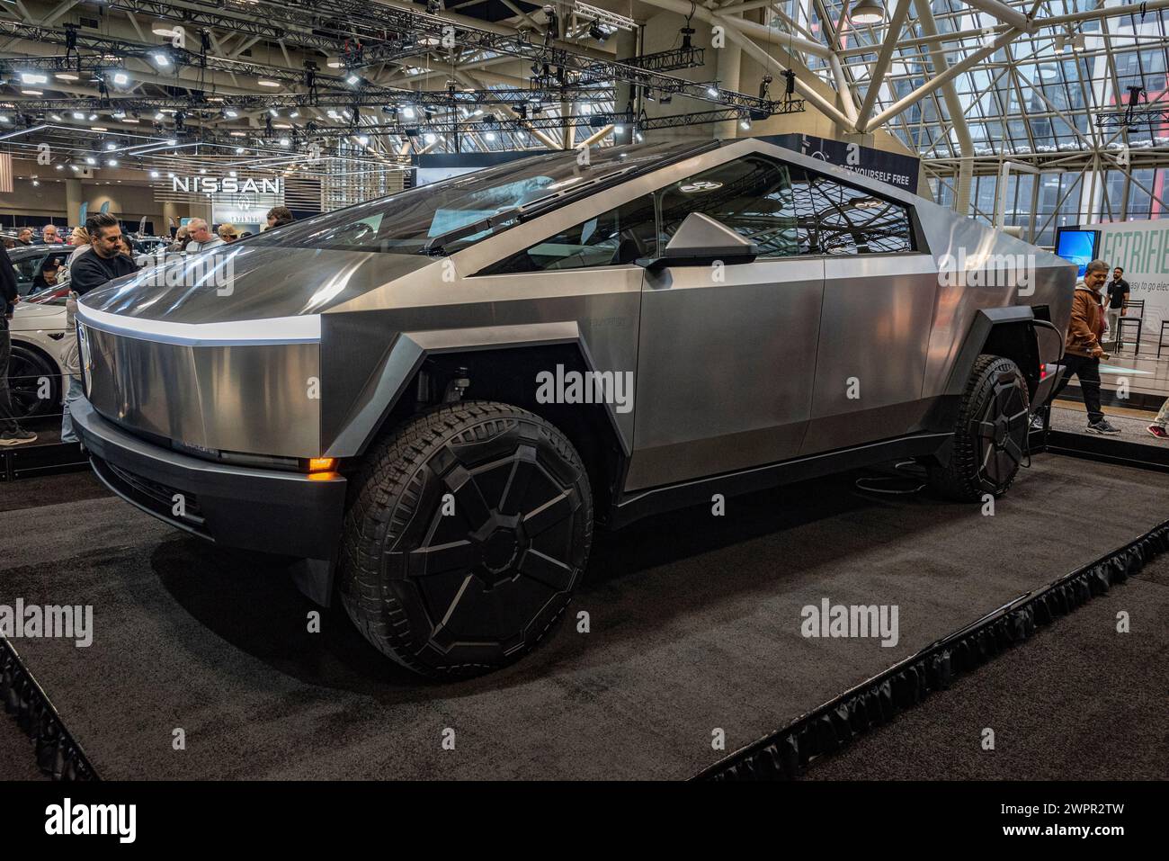 The Tesla Cybertruck is an electric pickup truck featuring a futuristic, angular design, advanced technological features, and a durable stainless stee Stock Photo