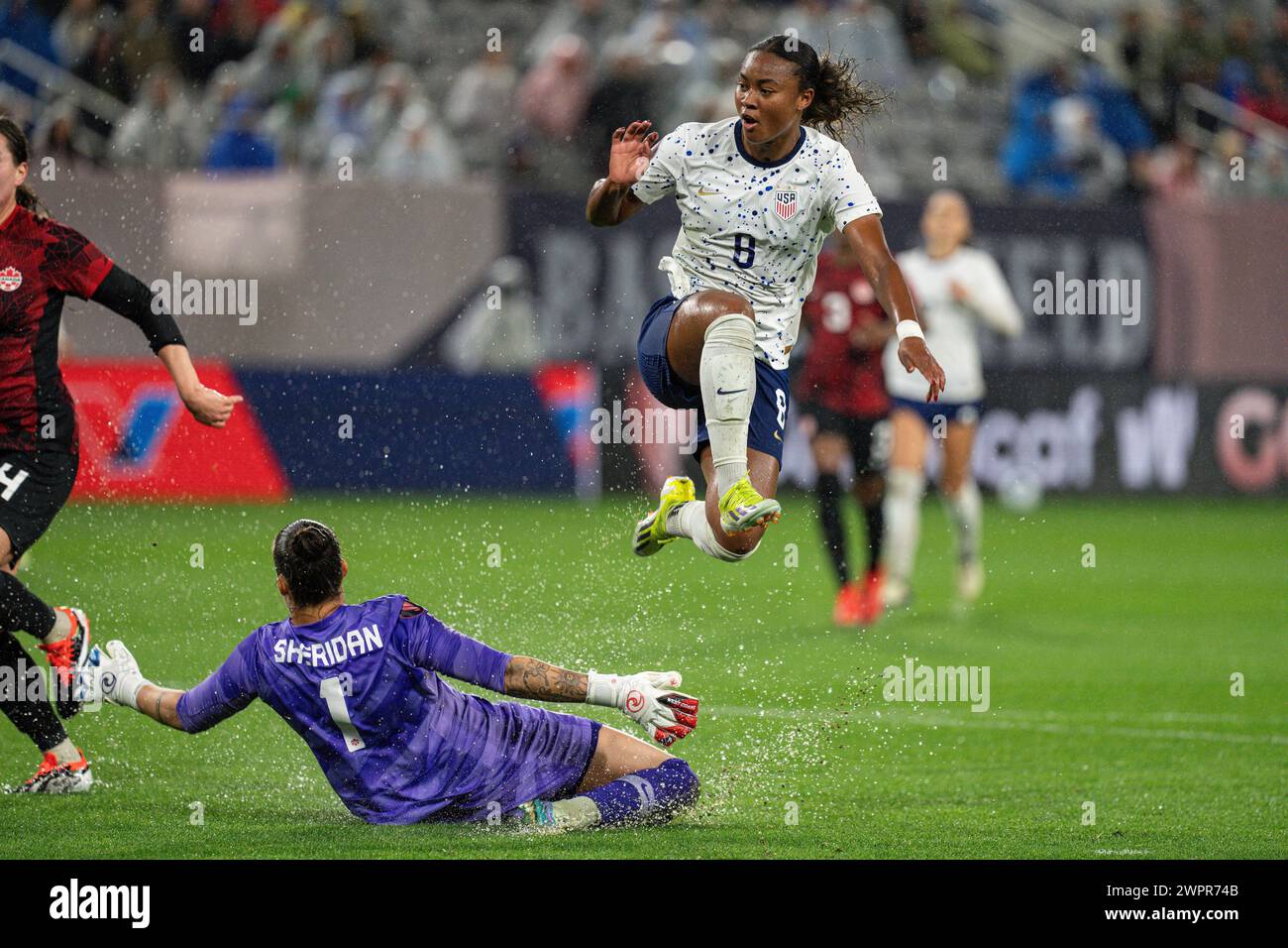 United States forward Jaedyn Shaw (8) scores against Canada goalkeeper Kailen Sheridan (1) during the Concacaf W Gold Cup semifinals match, Wednesday, Stock Photo
