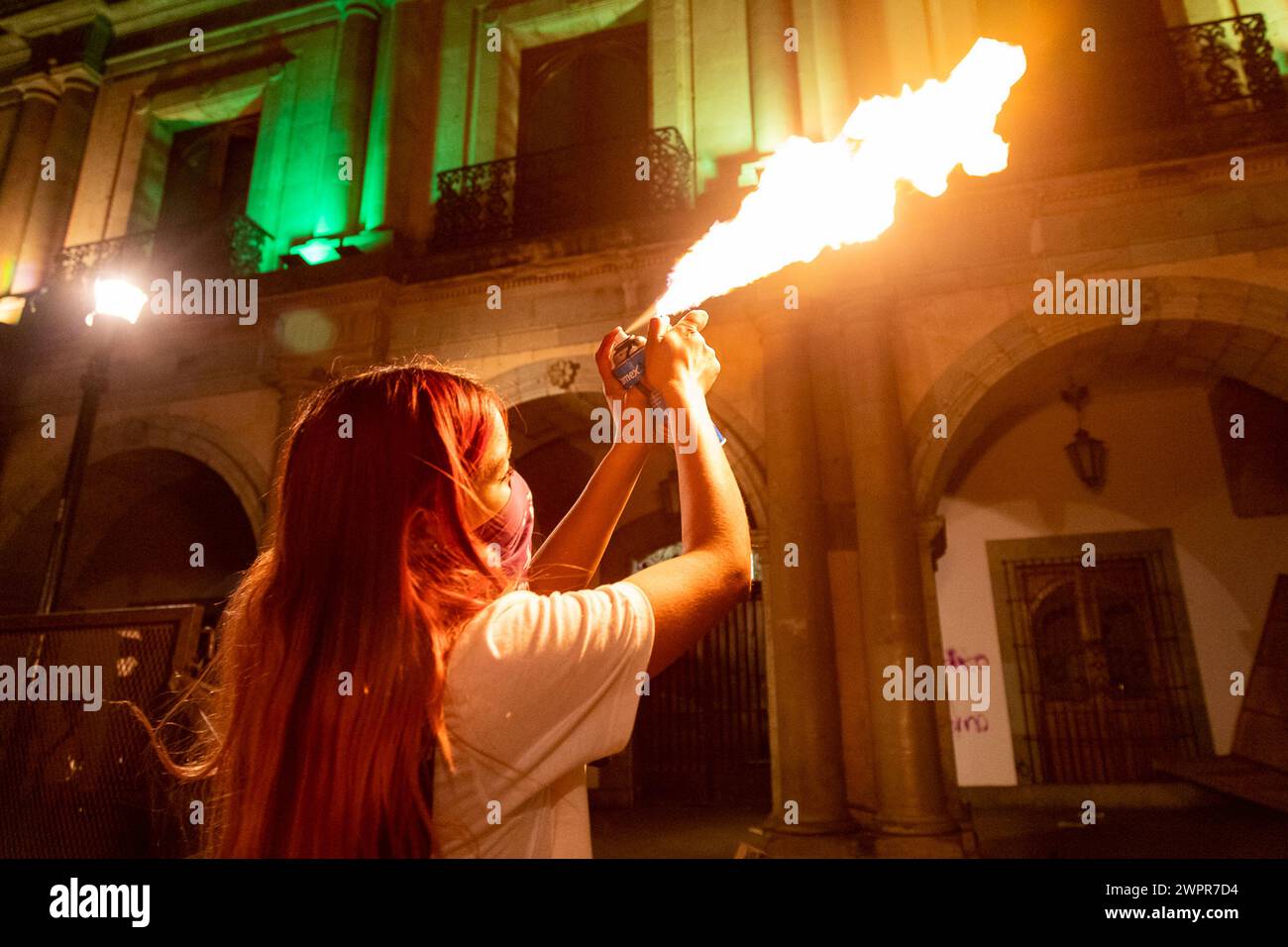March 8, 2024, Playa del Carmen, Mexico A woman sprays fire from an