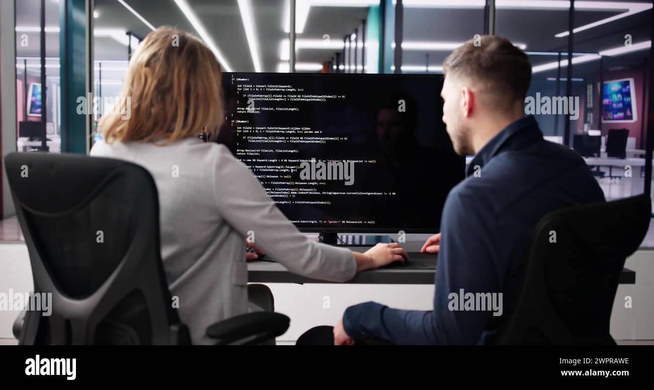 Computer Programmer Using Development Software On Laptop Stock Photo