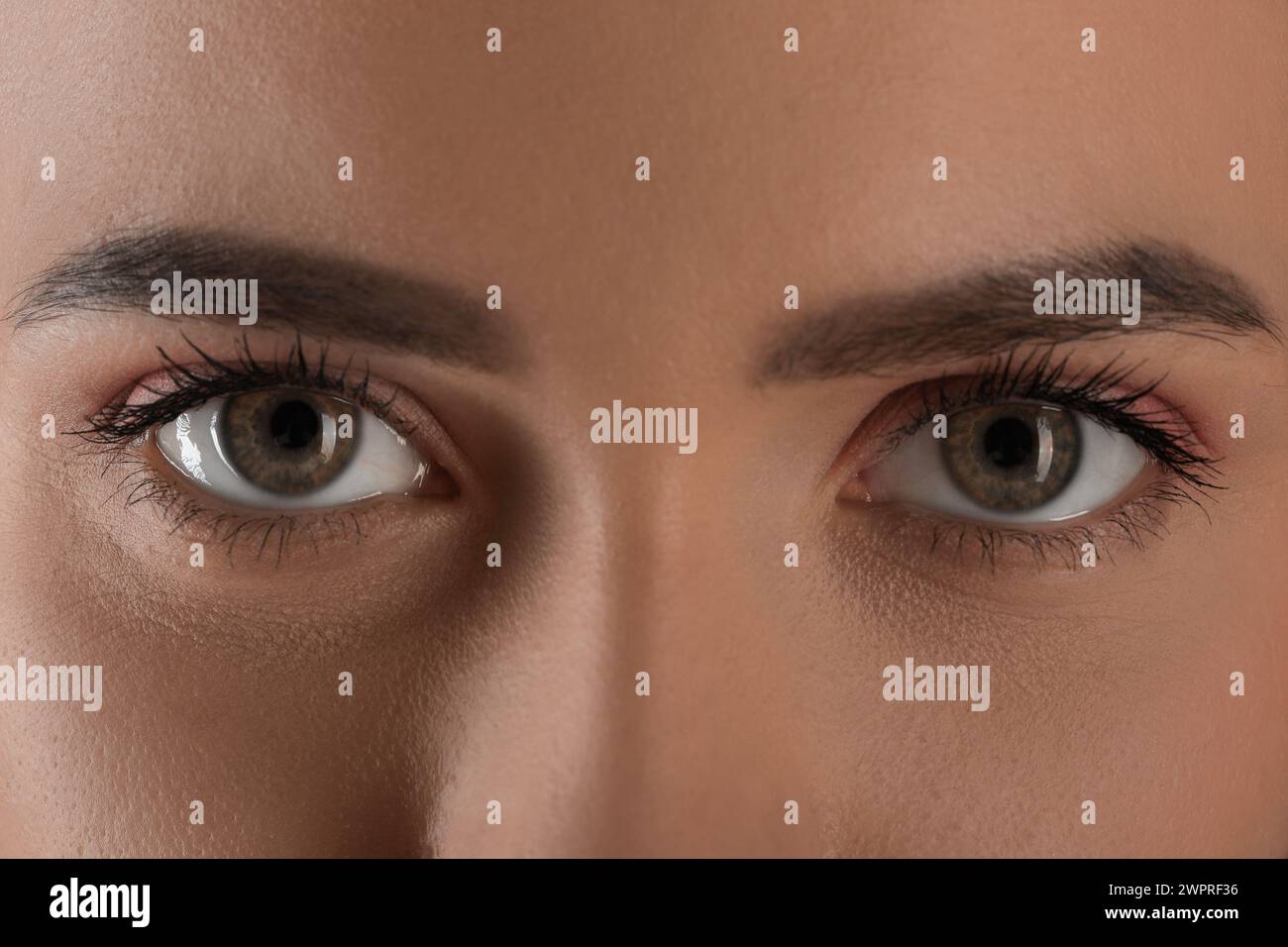 Evil eye. Young woman with scary eyes, closeup Stock Photo