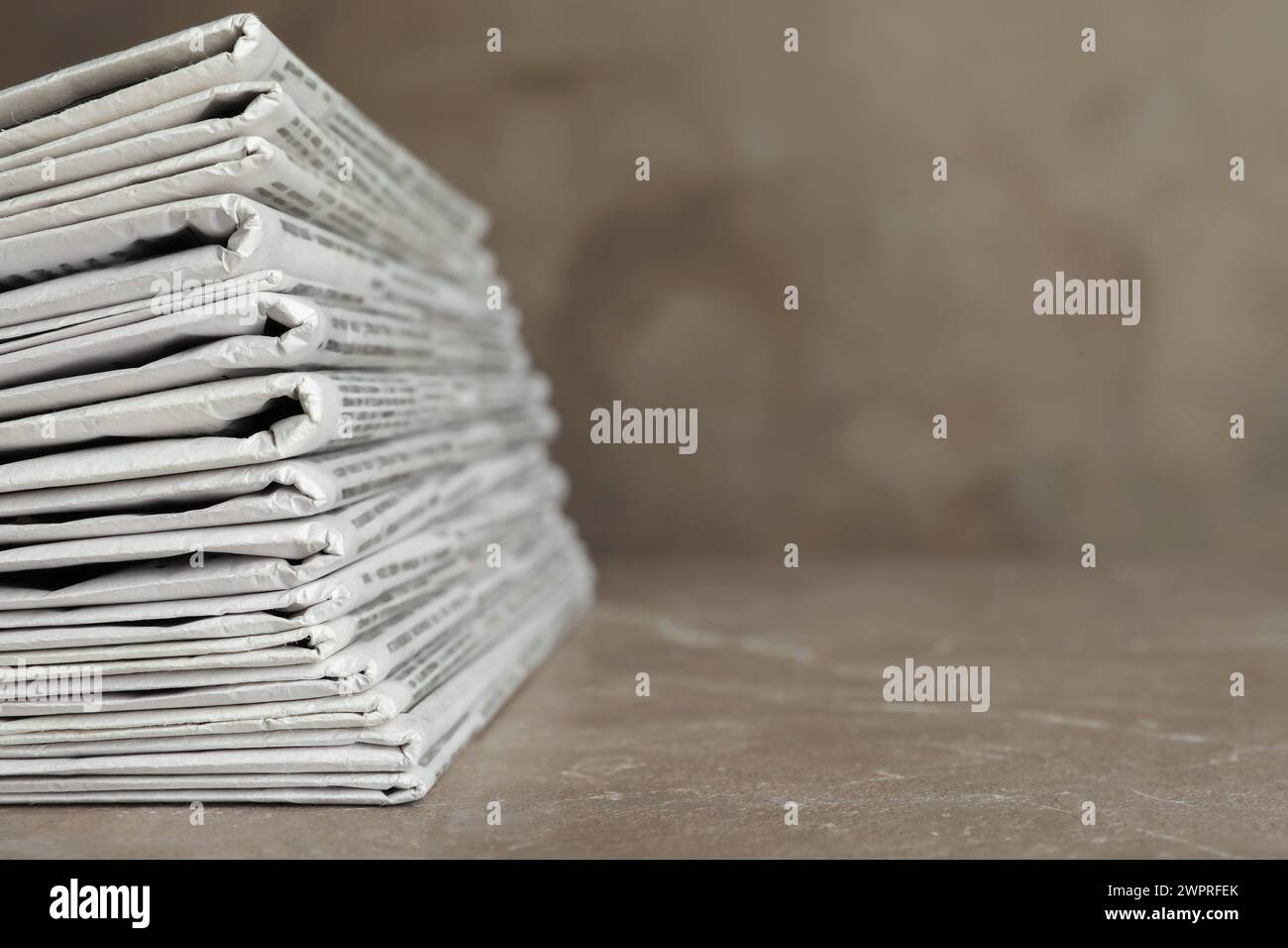 Stack of newspapers on marble table, closeup. Journalist's work Stock Photo