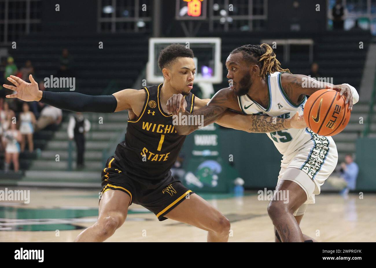 New Orleans, USA. 08th Mar, 2024. Wichita State Shockers guard Xavier Bell (1) tries to strip the ball from Tulane Green Wave guard Jaylen Forbes (25) during an American Athletic Conference men's basketball game at Fogleman Arena in New Orleans, Louisiana on Friday, March 8, 2024. (Photo by Peter G. Forest/Sipa USA) Credit: Sipa USA/Alamy Live News Stock Photo