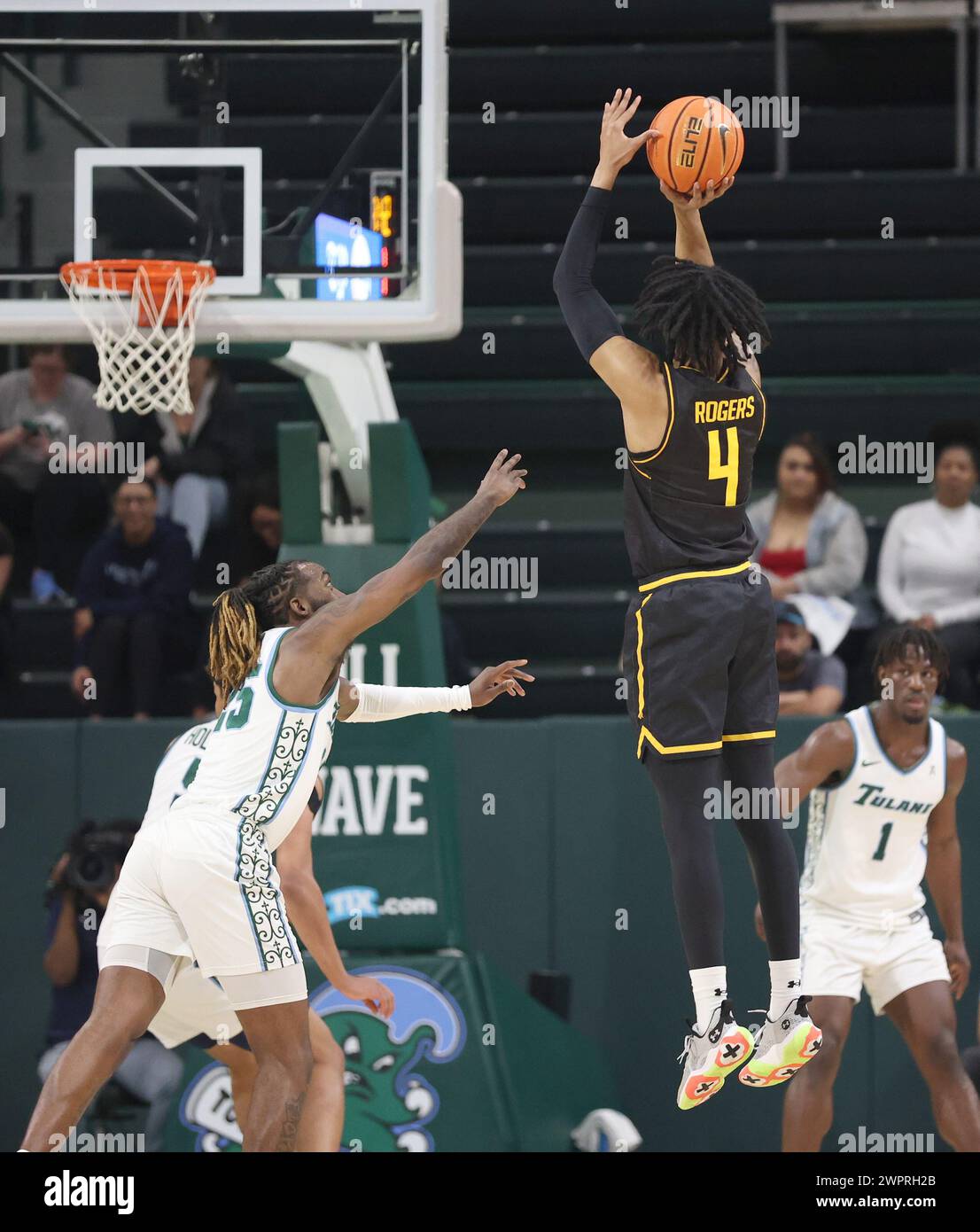 New Orleans, USA. 08th Mar, 2024. Wichita State Shockers guard Colby Rogers (4) shoots a three-pointer over Tulane Green Wave guard Jaylen Forbes (25) during an American Athletic Conference men's basketball game at Fogleman Arena in New Orleans, Louisiana on Friday, March 8, 2024. (Photo by Peter G. Forest/Sipa USA) Credit: Sipa USA/Alamy Live News Stock Photo