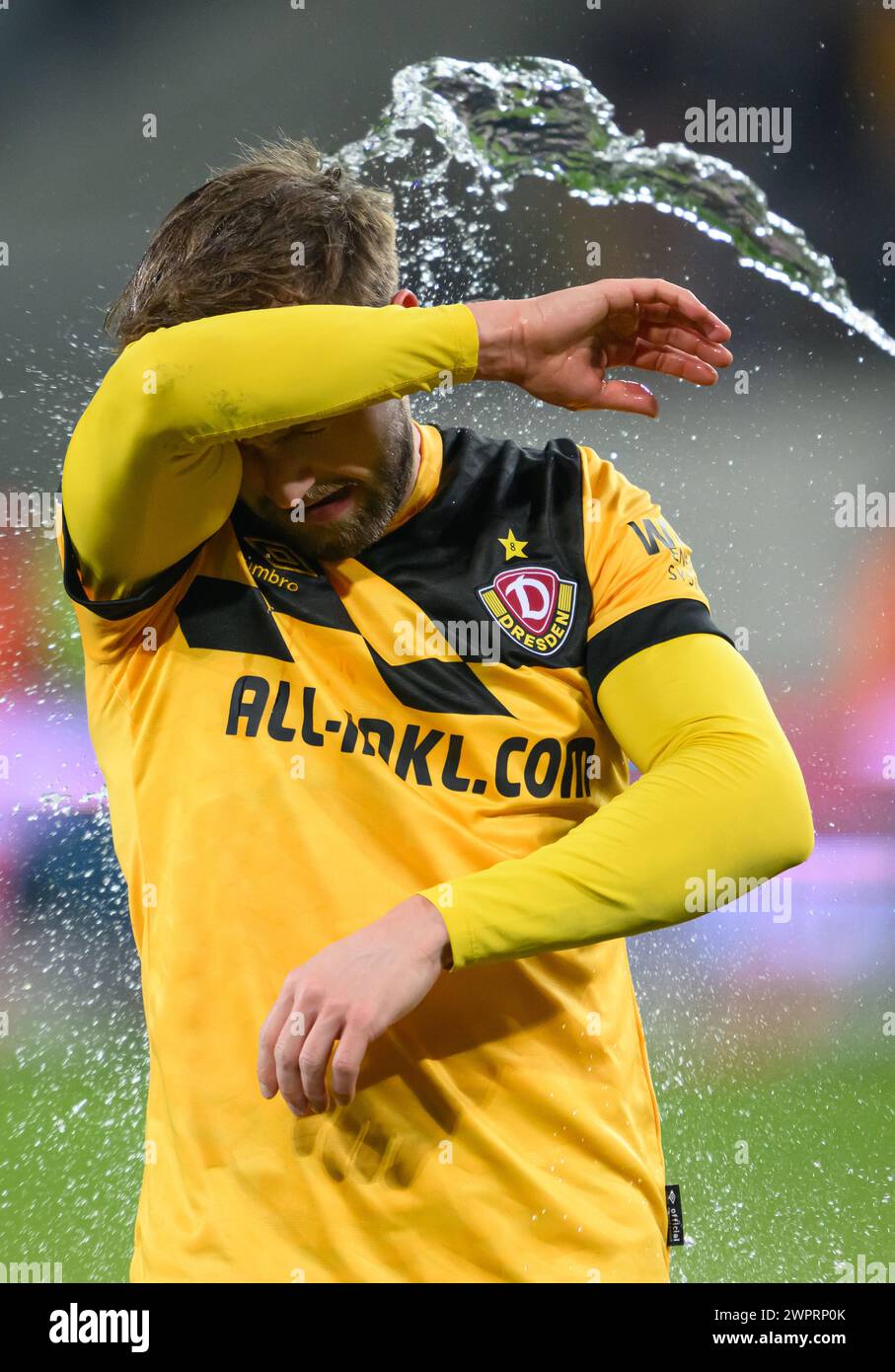 Dresden, Germany. 08th Mar, 2024. Soccer: 3rd division, SG Dynamo Dresden - TSV 1860 Munich, matchday 29, Rudolf-Harbig-Stadion. Dynamo's Lucas Cueto is splashed with water after the win. Credit: Robert Michael/dpa/Alamy Live News Stock Photo
