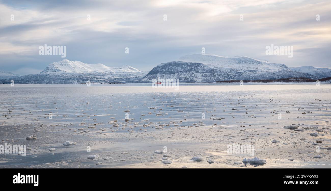 Rugged fjord landscape with snowcapped mountains of Vågsfjorden near Harstad in northern Norway. Stock Photo