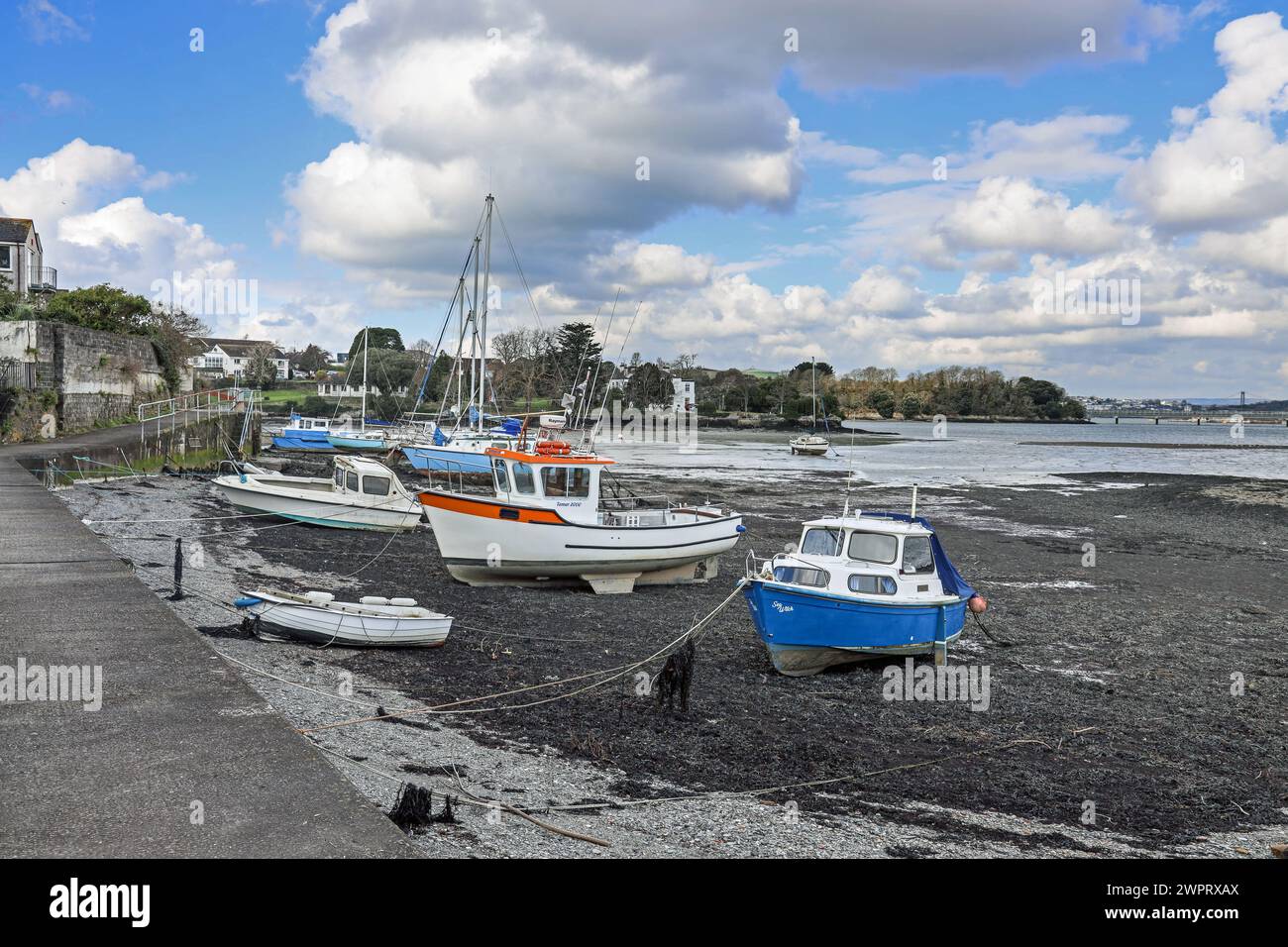 The riverside at Torpoint in south east Cornwall, with boats berthed on banks of the River Tamar Stock Photo