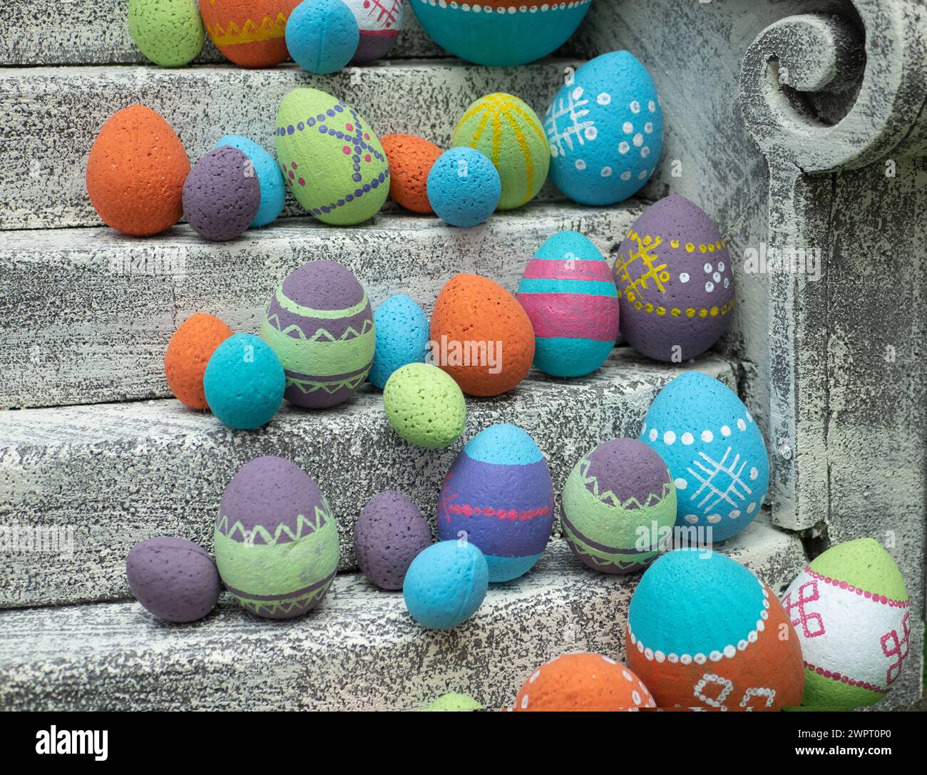 Decorative Easter eggs with a pattern on the stairs, selective focus. Multicolored Paschal eggs rows. Stock Photo
