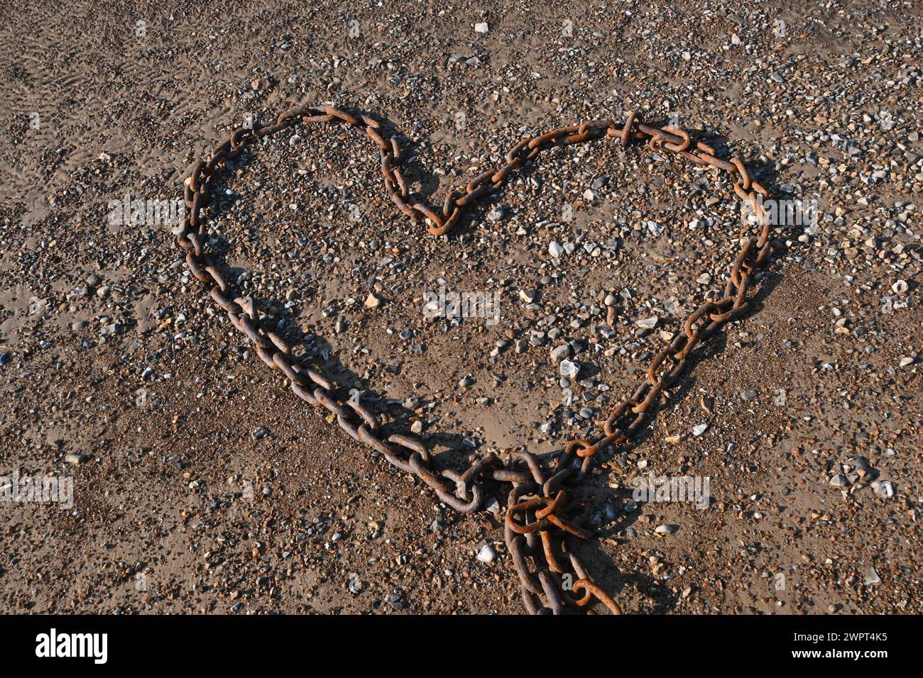 heart shaped metal chain on beach Stock Photo