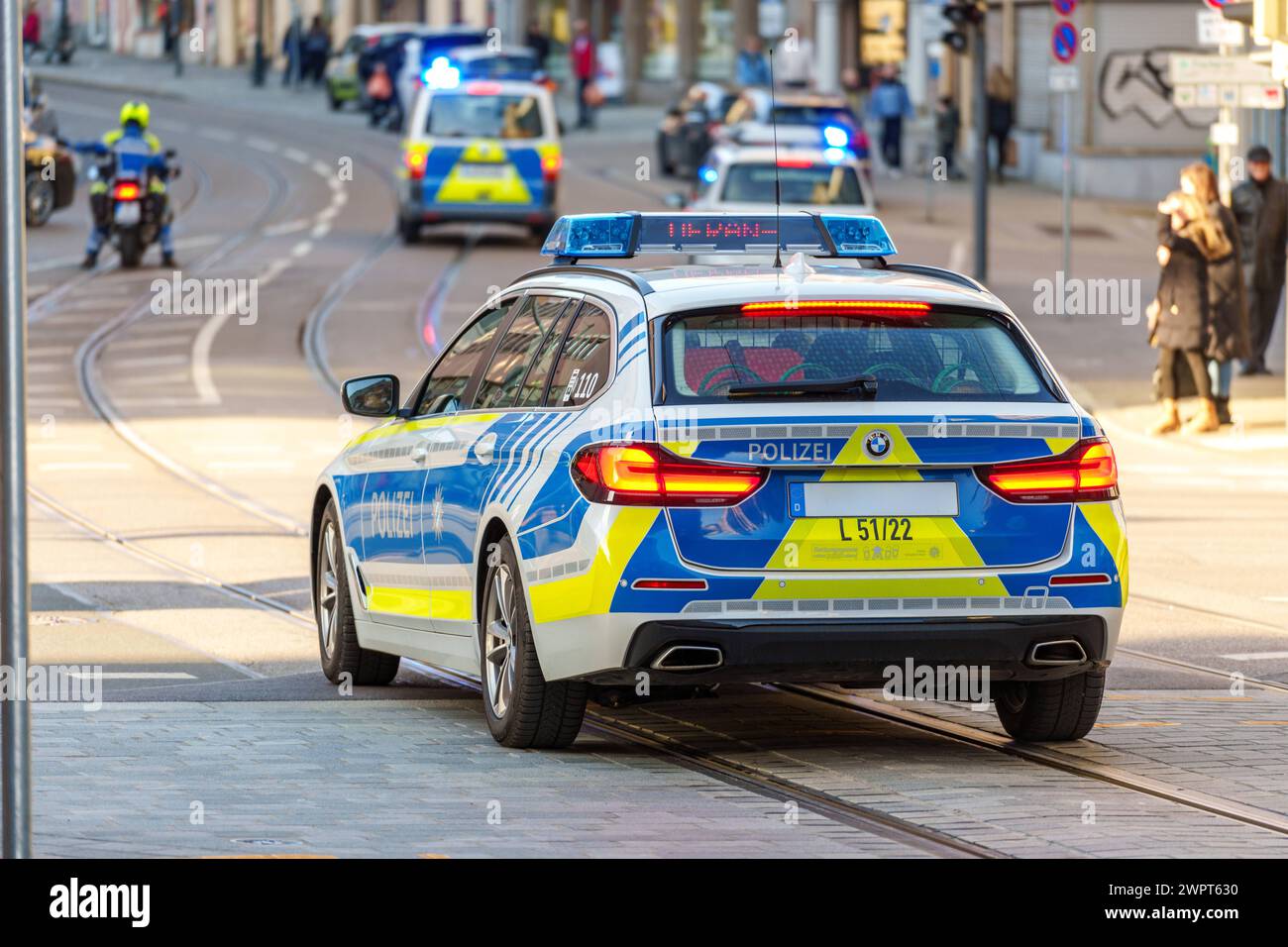 Augsburg, Bavaria, Germany - March 8, 2024: Bavarian police emergency vehicles accompany a demonstration with blue lights *** Bayerische Polizei Einsatzfahrzeuge begleiten mit Blaulicht eine Demonstration Stock Photo