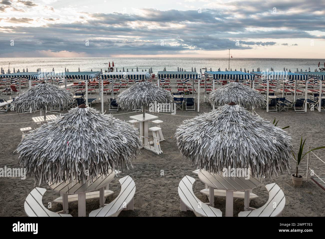 Empty beach and beach loungers, sunrise, Spotorno, Riviera di Ponente, Liguria, Italy Stock Photo