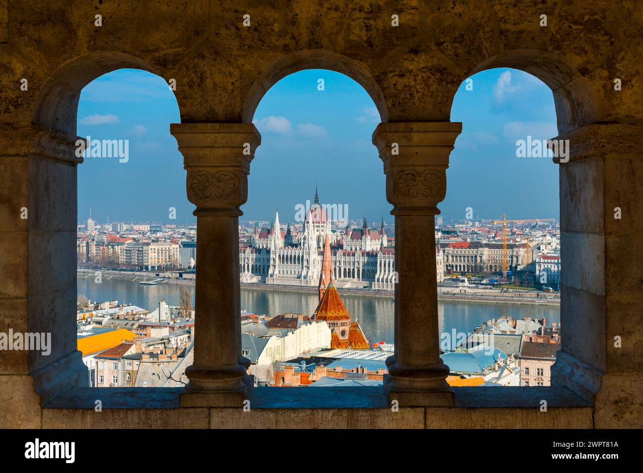 View through the facade of the Fisherman's Bastion to the Danube and the Parliament, politics, city view, travel, city trip, tourism, overview Stock Photo
