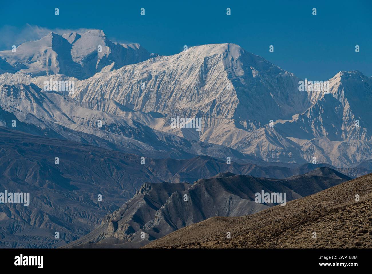 Desert landscape before the Annapurna mountain range, Kingdom of Mustang, Nepal Stock Photo
