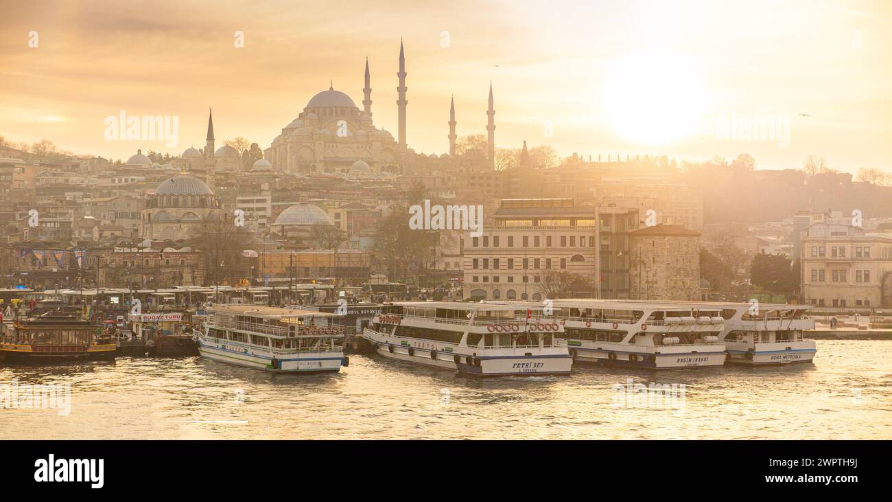 Golden hour in Istanbul with Fatih mosque in the distance and boats on the Bosphorus as the sun sets. Stock Photo