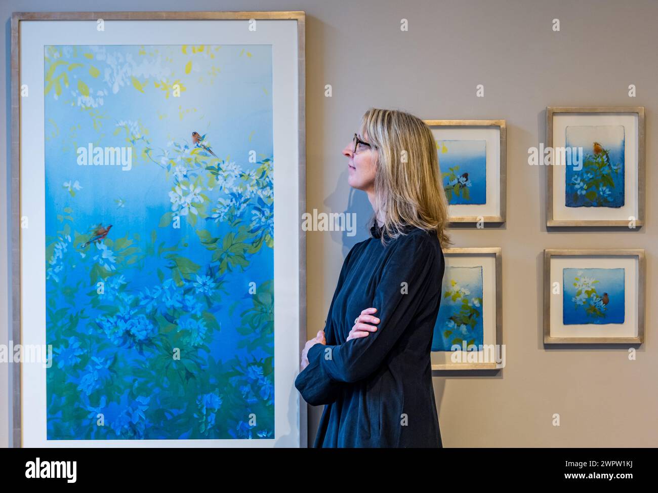 Edinburgh, Scotland, UK, 9th March 2024. The Scottish Gallery: a new exhibition at the New Town art gallery. Pictured: Artist Claire Harkess and some of her colourful bird watercolours. Credit: Sally Anderson/Alamy Live News Stock Photo