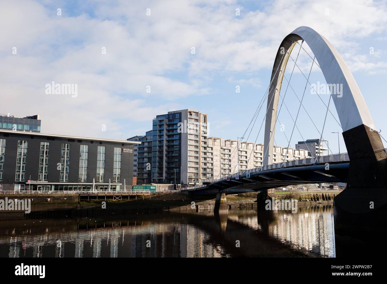 Glasgow Scotland: 13th Feb 2024: The Clyde Arc (Squinty Bridge) with Hilton Garden Inn Glasgow on the banks of River Clyde Stock Photo