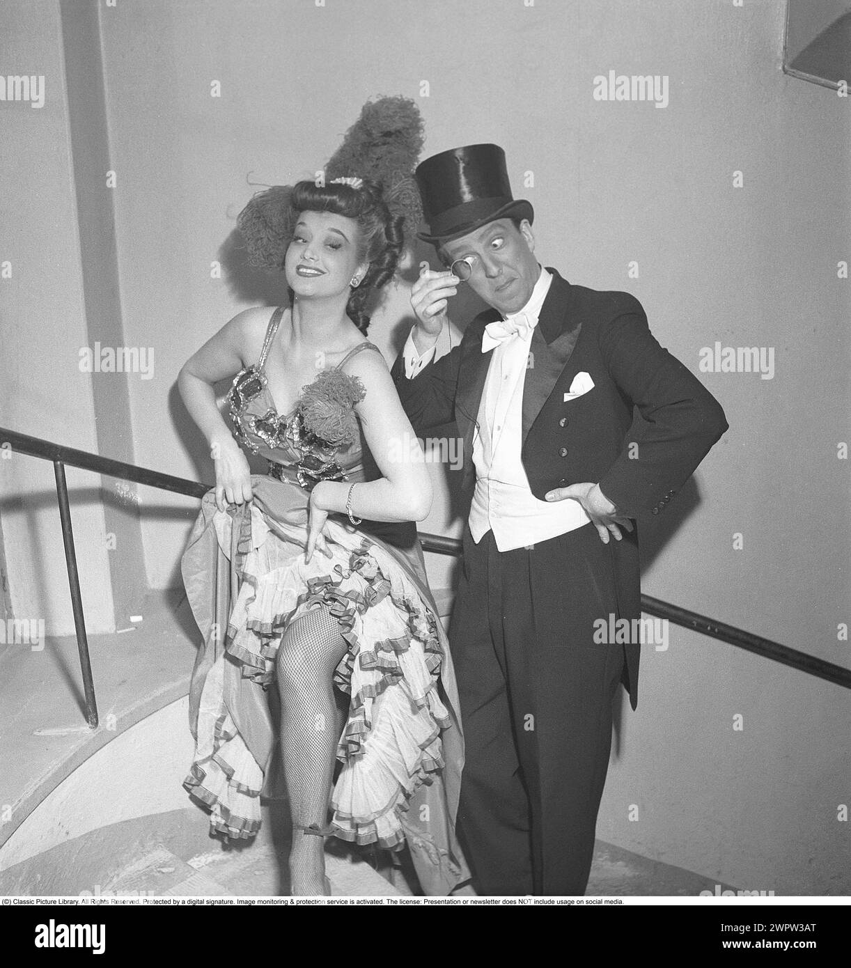 At The Theater In 1950 A Man And A Woman Dressed In Their Stage at-the-theater-in-1950-a-man-and-a-woman-dressed-in-their-stage